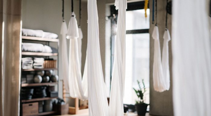 A peaceful yoga studio featuring aerial yoga hammocks for fitness and relaxation.
