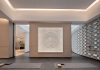 Spacious modern yoga studio interior featuring a striking wall art piece and yoga mats on wooden flooring.
