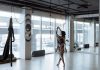 Woman practicing yoga gracefully in a modern, airy studio with natural light streaming in.