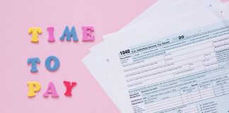 1040 tax forms with colorful 'Time to Pay Taxes' letters.