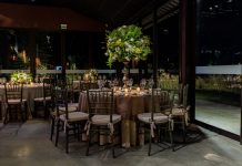 Luxurious indoor dining scene with floral decorations and elegant table settings.