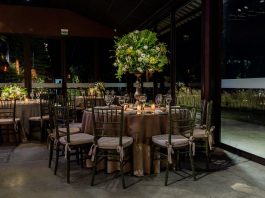 Luxurious indoor dining scene with floral decorations and elegant table settings.