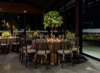 Luxurious indoor dining scene with floral decorations and elegant table settings.