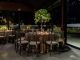 Luxurious indoor dining scene with floral decorations and elegant table settings.