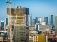 Aerial view of modern skyscrapers in Manchester with ongoing construction highlighting urban growth.