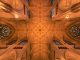 Intricate architecture and stained glass windows of St. Patrick's Cathedral ceiling in New York City.