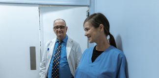Doctors and nurses interacting in a hospital hallway, showcasing teamwork and professionalism.