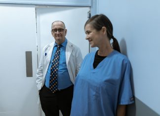 Doctors and nurses interacting in a hospital hallway, showcasing teamwork and professionalism.