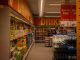Colorful drink aisle in a supermarket with signage promoting deals.