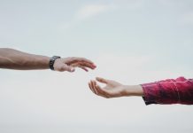 New County Initiative Aims to Connect Residents to Addiction Treatment Two hands reaching towards each other, symbolizing connection and support.