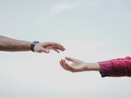 New County Initiative Aims to Connect Residents to Addiction Treatment Two hands reaching towards each other, symbolizing connection and support.
