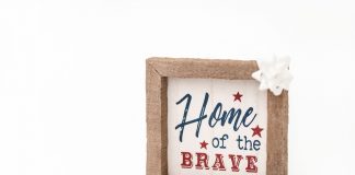 Patriotic framed sign with 'Home of the Brave' text and festive bows, perfect for home decor.