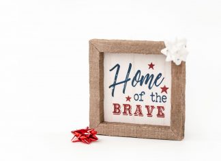 North Bergen Celebrates U.S. 250th Anniversary With Poster Display Patriotic framed sign with 'Home of the Brave' text and festive bows, perfect for home decor.