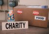 Image of a charity donation box filled with food supplies and paper cups.