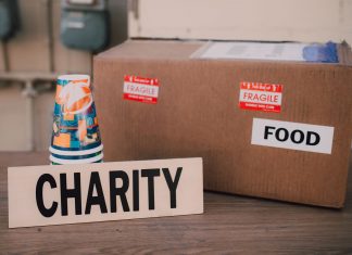 Image of a charity donation box filled with food supplies and paper cups.