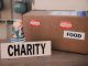 Image of a charity donation box filled with food supplies and paper cups.