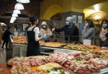 Salumeria Ercolano Moves Into Historic Miss America Diner Space Shoppers wearing masks buy pizza slices from a bakery in Bergamo, Italy.