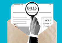 Solomon Blames Fulop for $109M in Unpaid Bills in Jersey City Budget Report Cutout paper composition of male with magnifier received expensive taxes and payments on blue background