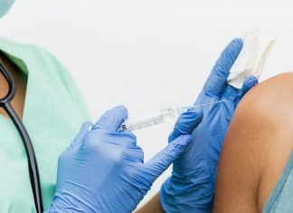 State Launches Push to Get Kids Vaccinated Ahead of Winter Close-up of a nurse in gloves giving a vaccination to a patient.