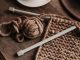 A close-up shot of cozy brown yarn and needles on a wooden table, showcasing knitting in progress.