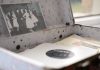 Open vintage floral suitcase with a classic photo and vinyl record inside.