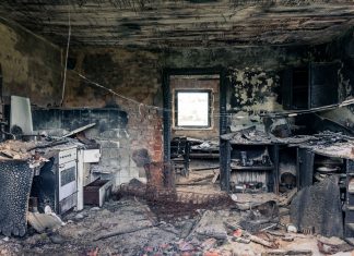 Explore an abandoned, fire-damaged kitchen illustrating decay and destruction.