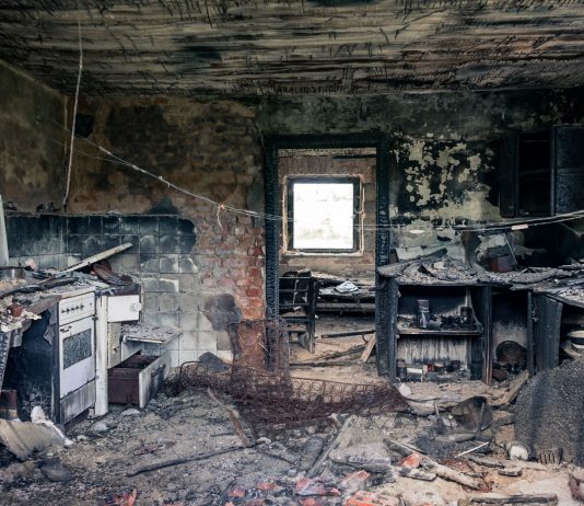 Explore an abandoned, fire-damaged kitchen illustrating decay and destruction.