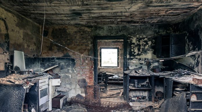 Explore an abandoned, fire-damaged kitchen illustrating decay and destruction.