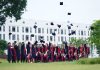 10 Jersey City Graduates Receive $1,000 Scholarships from Public Schools Foundation A group of graduates in Vietnam celebrate by throwing caps into the air.