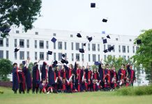10 Jersey City Graduates Receive $1,000 Scholarships from Public Schools Foundation A group of graduates in Vietnam celebrate by throwing caps into the air.