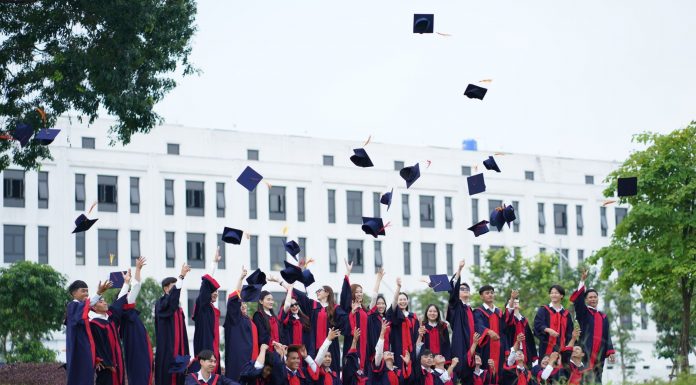 10 Jersey City Graduates Receive $1,000 Scholarships from Public Schools Foundation A group of graduates in Vietnam celebrate by throwing caps into the air.