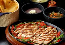 Tasty Mexican grilled chicken fajitas with colorful vegetables, tortillas, and sides, perfect for a savory meal.