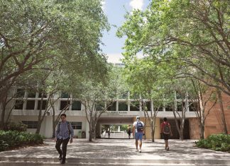 Students walking through a sunlit university campus in Coral Gables, Florida.