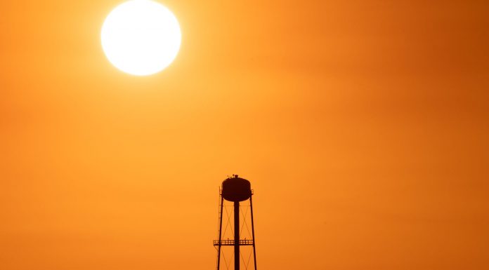 A Jersey City Heat Wave in Photos A striking sunset silhouette of a water tower against a vivid orange sky in Mather, CA.