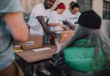 Volunteers handing out donations and support to those in need at a community event.