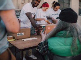 Volunteers handing out donations and support to those in need at a community event.