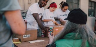 Volunteers handing out donations and support to those in need at a community event.