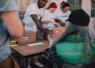 Volunteers handing out donations and support to those in need at a community event.