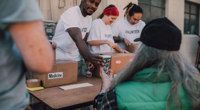 Volunteers handing out donations and support to those in need at a community event.