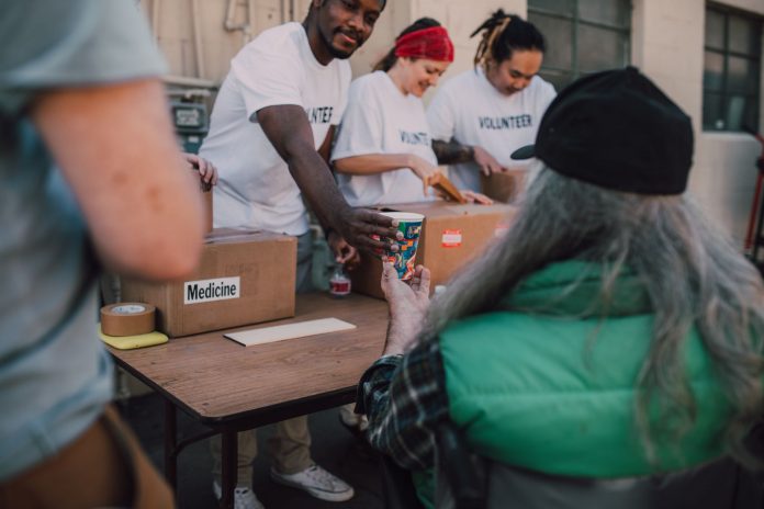 a-year-of-giving-jersey-city-nonprofit-celebrates- Volunteers handing out donations and support to those in need at a community event.