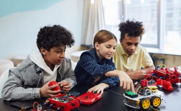 Diverse kids collaborating on robotics project, promoting STEM learning in a creative environment.