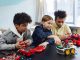 Diverse kids collaborating on robotics project, promoting STEM learning in a creative environment.