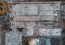 Bayonne Planning Board to Weigh 165-Unit Peninsula View Project Drone shot of a large vacant lot in Scotland, showcasing concrete and debris.