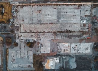 Drone shot of a large vacant lot in Scotland, showcasing concrete and debris.