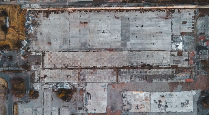 Drone shot of a large vacant lot in Scotland, showcasing concrete and debris.