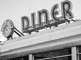 Best Breakfast Spots in Bayonne: A Local Guide for 2026 Black and white photo of a vintage diner sign with a clock in Somerville, MA.