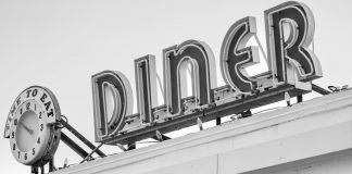 Best Breakfast Spots in Bayonne: A Local Guide for 2026 Black and white photo of a vintage diner sign with a clock in Somerville, MA.