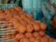 Close-up of skewered fried street food balls, perfect for food and travel visuals.