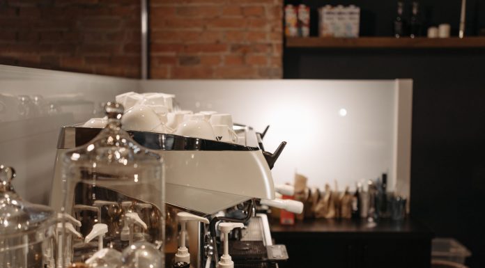 A cozy coffee shop interior featuring a modern espresso machine and various coffee accessories.