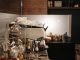 A cozy coffee shop interior featuring a modern espresso machine and various coffee accessories.